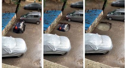 ¿Otro SOCAVÓN? Enorme hoyo se 'traga' en segundos un COCHE estacionado: VIDEO VIRAL